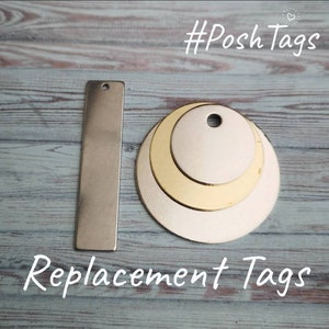 May include: Three metal replacement tags, two round and one rectangular, with a hole for attaching to a product. The tags are silver and gold in color. #Posh Tags Replacement Tags