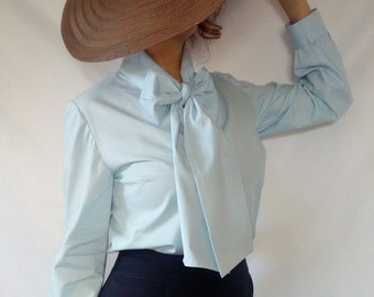 Light blue cotton blouse with a tie collar