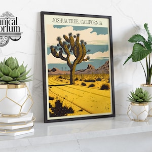 May include: A framed vintage-style poster with the text "Joshua Tree, California" and an illustration of a Joshua Tree in a desert landscape. The poster is displayed on a shelf with three potted plants.