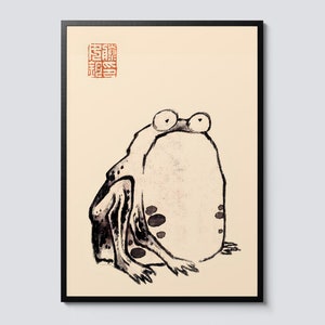 May include: A black and white ink drawing of a frog with a large belly and large eyes. The frog is sitting on a light beige background with a red stamp in the top right corner. The stamp contains Chinese characters.