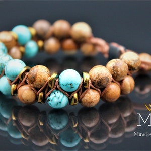 May include: A double-strand bracelet with brown and turquoise beads, accented with gold spacers and brown leather cord.