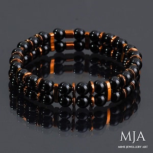 May include: A double-strand bracelet with black onyx beads and copper spacers. The bracelet is made of natural stones and is a stylish accessory for any occasion.