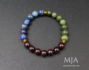 Pode incluir: Um bracelete de contas multicoloridas com contas azuis, verdes e vermelhas separadas por espaçadores dourados. O bracelete é feito de pedras naturais e tem um design simples.