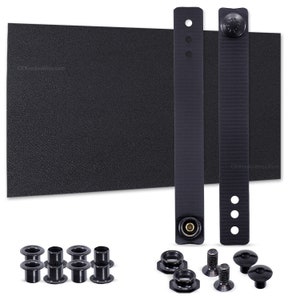 May include: A black, textured, rectangular sheet of material with two black straps and a set of black metal hardware, including grommets, screws, and washers.