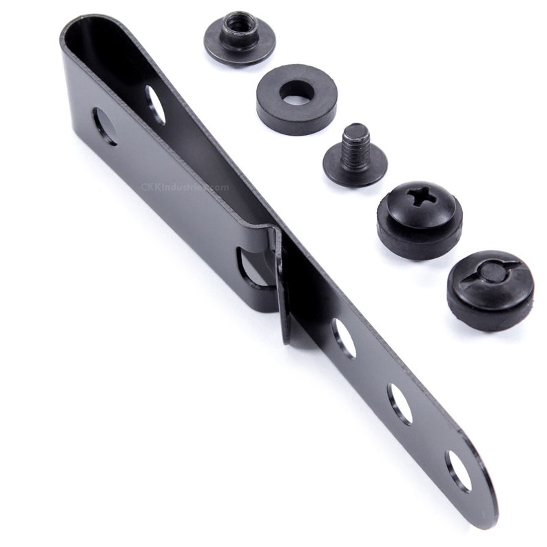 May include: Black metal clip with six holes and a curved end. The clip is accompanied by five black metal screws and washers.