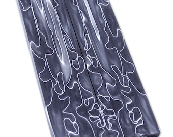 May include: Two pieces of black and white patterned wood, suitable for crafting projects like knife handles.