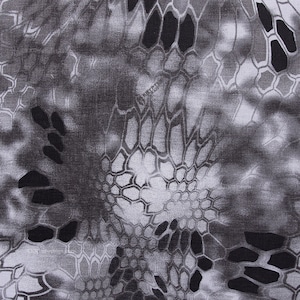 May include: A close-up of a black and white camouflage pattern. The pattern is made up of small, irregular shapes that resemble scales or a snake skin.
