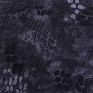 May include: A dark blue fabric with a camouflage pattern. The pattern is made up of small, irregular shapes in shades of gray and black.
