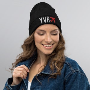 May include: Black knit beanie with a white "YVR" and red airplane graphic.