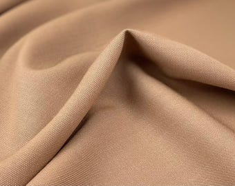 May include: Close-up of a brown fabric with a subtle texture. The fabric is smooth and has a soft, warm tone.