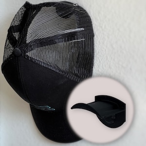 May include: Black baseball cap with a mesh back and a black hat rack.