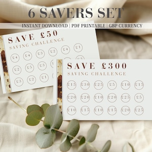May include: Two rectangular paper saving challenge cards with a white background and a brown marbled vertical stripe on the left. The cards feature the text SAVE £50 and SAVE £300 with rows of circles containing various pound sterling amounts.
