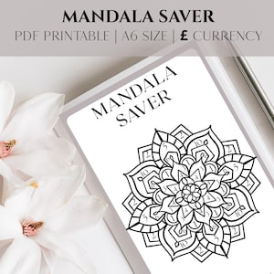 May include: A black and white mandala design on a white PDF printable. The text "MANDALA SAVER" is displayed at the top and on the printable. A silver pen rests on the side, and white flowers are in the background.