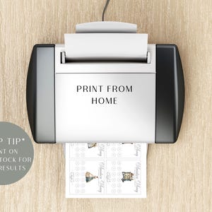 May include: A white and black printer with the text PRINT FROM HOME printed on the front. A sheet of paper with small printed graphics and circular icons is emerging from the bottom. A grey circular badge displays the text *TOP TIP* PRINT ON CARD STOCK FOR BEST RESULTS.