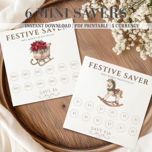 Puede incluir: Dos rastreadores de ahorro de papel cuadrados con el texto FESTIVE SAVER y SAVE MONEY BEAUTIFULLY. Uno presenta un trineo lleno de flores de pascua rojas con círculos de 50 centavos y SAVE $6. El otro muestra un caballito con círculos de $3 y SAVE $36.