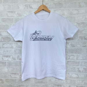 May include: White t-shirt with a blue graphic print of a cartoon character with the text "MIKU HATsune 01" and a star.