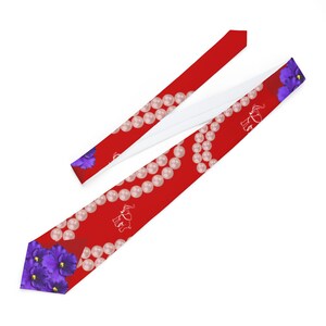 May include: Red necktie with a pattern of white pearls, white elephant silhouettes, and purple flowers. The tie is made of a smooth fabric and has a white lining. The tie is a standard length.