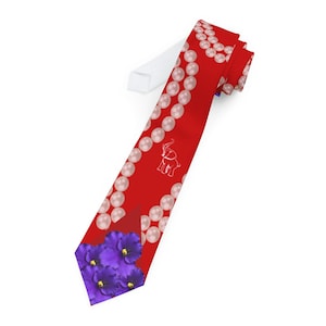 May include: A red necktie featuring a pattern of faux pearls, a white elephant logo, and a cluster of purple flowers. The tie is made of a smooth fabric and is suitable for formal or semi-formal occasions.