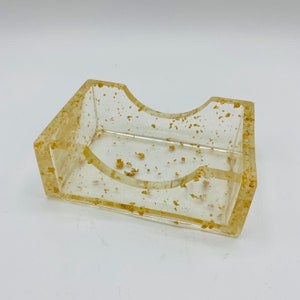 Clear lucite with gold fleck soap dish or business card dish.