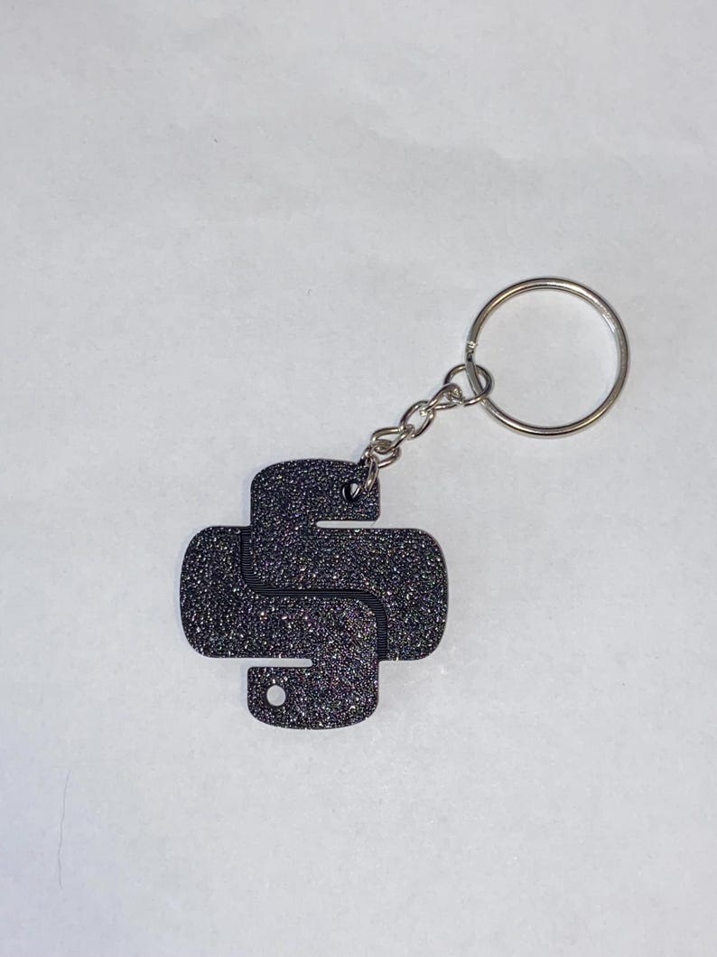 May include: A black glitter Python logo keyring with a silver key ring.