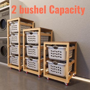 May include: Laundry room with multiple wooden rolling laundry sorters. Each sorter has white plastic laundry baskets with a geometric pattern. The text "2 bushel Capacity" is displayed in orange.