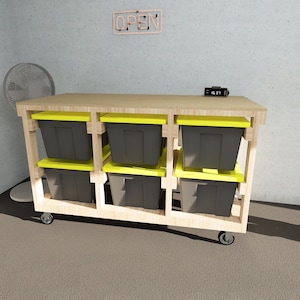 May include: A wooden storage cart with six black storage bins and yellow lids. The cart has wheels and is on a gray floor. The cart is in front of a gray wall with a neon sign that says "OPEN".