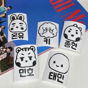May include: Five white stickers with black cartoon animal illustrations and Korean text. The stickers feature a bunny, a cloud, a bear, a tiger, and a round character. The text on the stickers reads "Romu", "Ki", "Chongyon", "Minho", and "Taemin".