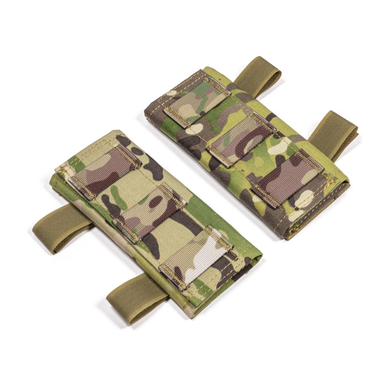 May include: Two camouflage-patterned tactical pouches with adjustable straps. The pouches have multiple compartments and are designed for attaching to a belt or vest.