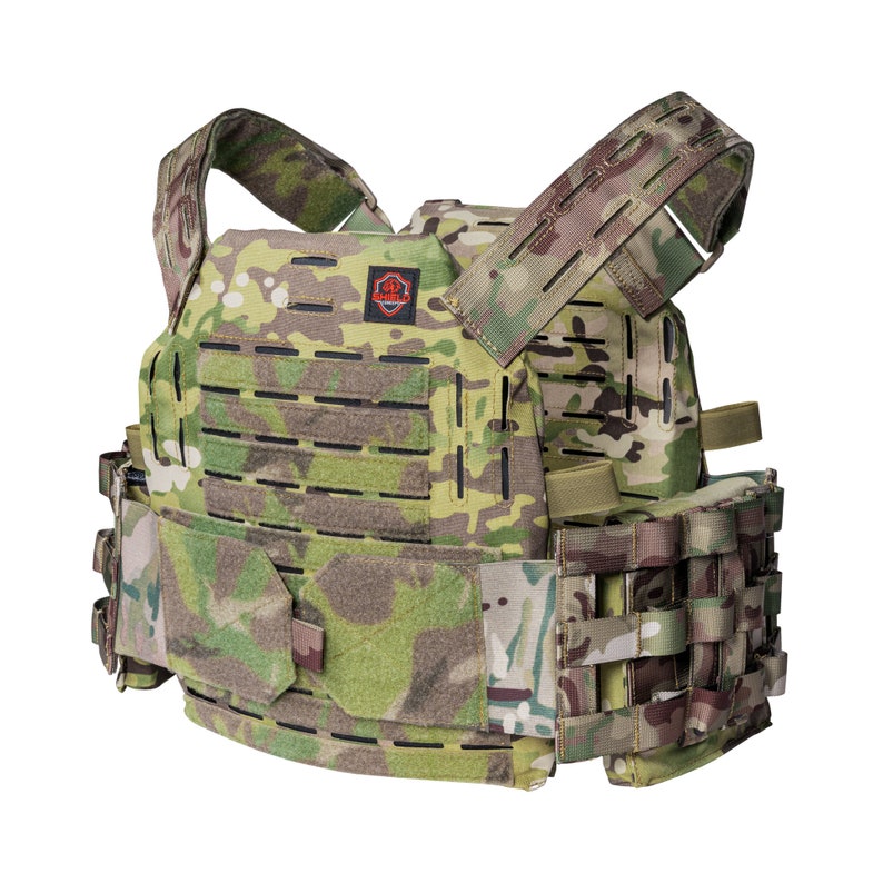 May include: A green and brown tactical vest with adjustable straps and a molle system. The vest has a patch with a red logo on the front.