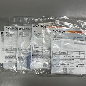 May include: A clear plastic bag containing several individually packaged medical extension tubes. Each package is labeled with the brand name "AVANOS" and the text "MIC EXTENSION TUBING". The packages also include product information and warnings.