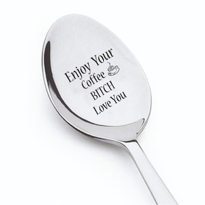 May include: A silver spoon with the text "Enjoy Your Coffee Bitch Love You" engraved on it. A small coffee cup icon is also engraved on the spoon.