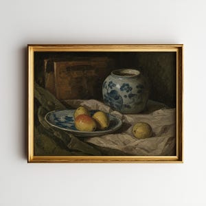 May include: A framed still life painting featuring a blue and white ceramic vase, a plate with fruit, and a wooden box. The painting has a gold frame and a muted color palette with a focus on the arrangement of objects.