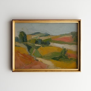 May include: An oil painting of a landscape with rolling hills and fields in shades of yellow, green, and orange. The artwork is framed in a gold-colored frame and hangs on a white wall.