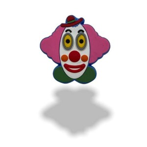 May include: A pink and white clown face with a red nose and blue hat. The clown has large yellow eyes and a wide smile.