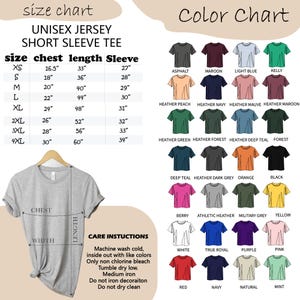 May include: A gray unisex short sleeve tee shirt is displayed on a hanger. The image includes a size chart with measurements in inches, a color chart with various shirt colors, and care instructions.