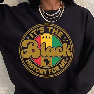 May include: Black sweatshirt with a gold, red, green, and yellow circle graphic that says "It's the Black History for Me".