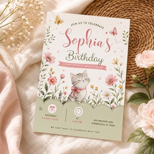 May include: A rectangular birthday invitation card featuring a grey kitten with a pink bow, surrounded by watercolour flowers and butterflies. The text reads: Join us to celebrate Sophia's Birthday, Let's make wonderful memories together, Saturday 24 May, 2025, at 2:00 PM, 456 Meadow Lane, Springfield, ST 78901, We can't wait to celebrate with you.