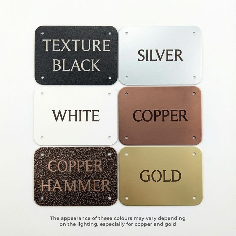 Metal plaques showing the six available colors: black, silver, white, copper, copper hammer and gold. There is a note that says "the appearance of these colours may vary depending on the lighting, especially for copper and gold".