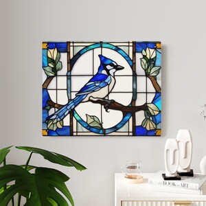 May include: A stained glass artwork depicting a blue jay perched on a branch with yellow flowers. The bird is surrounded by a geometric pattern of blue, green, and brown glass.