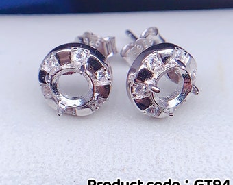 May include: Sterling silver earring settings with a round bezel and a row of small clear cubic zirconia stones around the edge. The settings are 5mm in diameter. Product code: GT94.