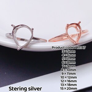 May include: Two sterling silver rings with pear-shaped settings. The ring on the left is silver, and the ring on the right is rose gold. The rings are available in sizes 3mm x 5mm to 15mm x 20mm. Product code: R1147.