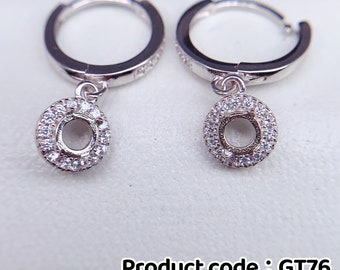 May include: Sterling silver hoop earrings with a dangling circle charm set with small clear cubic zirconia stones. Product code: GT76 4x4mm.