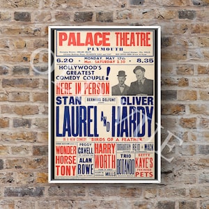 May include: A framed vintage poster for a Laurel and Hardy comedy show at the Palace Theatre in Plymouth. The poster features text in red, blue, and white, with images of the comedy duo and other performers.