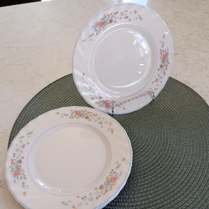 May include: A set of three ceramic mugs with a speckled, matte finish. Each mug features a different color: light blue, cream, and gray. The mugs have a simple, modern design and a comfortable handle.
