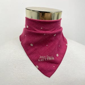 May include: A pink bandana with white polka dots and the text "Jean Paul GAULTIER" in white.