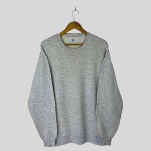 May include: A heather gray crew neck sweatshirt hanging on a wooden hanger. The long-sleeved top has a ribbed collar, cuffs, and hem. The sweatshirt is made of a soft, comfortable material.