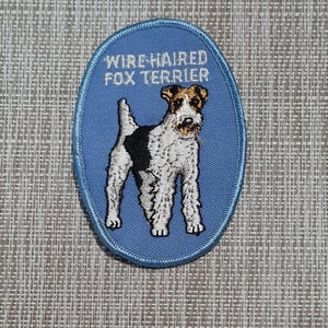 May include: Blue embroidered patch with a white wire-haired fox terrier dog and the text "Wire-haired Fox Terrier".
