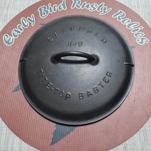 May include: A black cast iron Griswold No. 9 Tite-Top Baster lid with a handle. The lid is on a red and brown background with the text "Early Bird Rusty Relics".