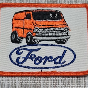 May include: Orange embroidered patch with a vintage Ford van and the word "Ford" in blue lettering.
