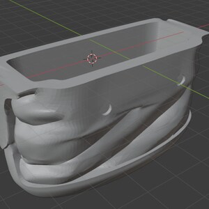 K&ouml;nnte beinhalten: Eine graue, 3D-gedruckte Form f&uuml;r einen Plastikbeh&auml;lter. Die Form hat einen glatten, abgerundeten Innenraum und eine strukturierte Au&szlig;enseite.